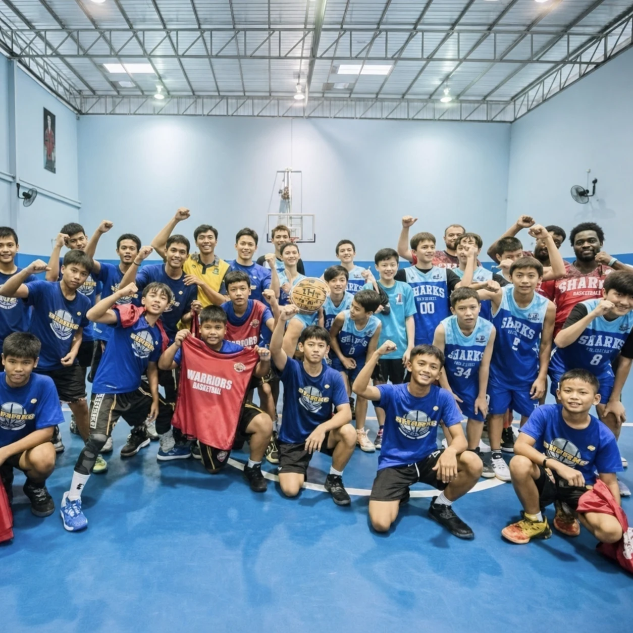 A large group of Sharks Basketball Academy players celebrating together after training
