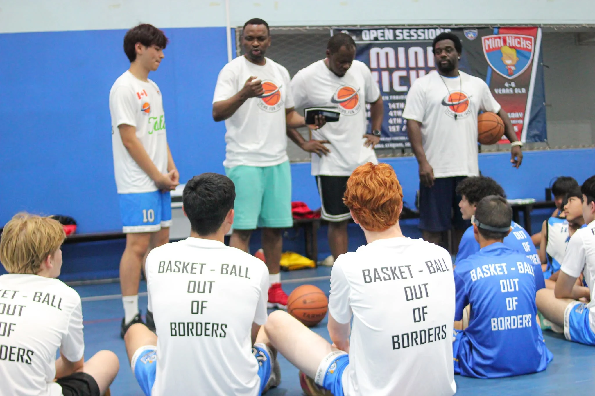 Sharks coaches speaking to players at an academy session